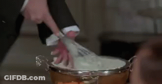 Man In Suit Cutting Cake With Scissors GIF