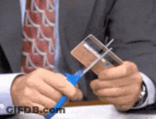 Man In Suit Cutting Credit Card With Scissors GIF