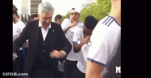 Man In Suit Dancing Before Group GIF