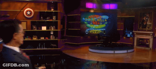 Man In Suit Dancing Before Super Colbchol Sign GIF