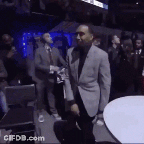 Man In Suit Dancing In Crowded Room GIF