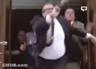 Man In Suit Dancing In Elevator With Others GIF