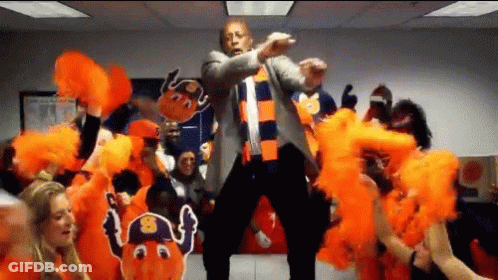 Man In Suit Dancing In Front Of Cheerleaders GIF