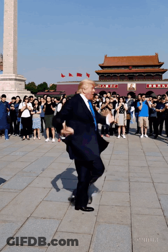 Man In Suit Dancing In Front Of Chinese Building GIF