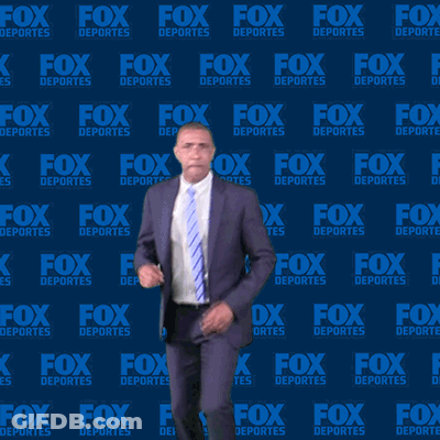 Man In Suit Dancing In Front Of Fox Deportes Wall GIF