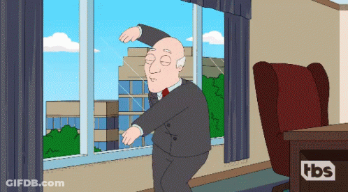 Man In Suit Dancing In Front Of TBS Logo Window GIF