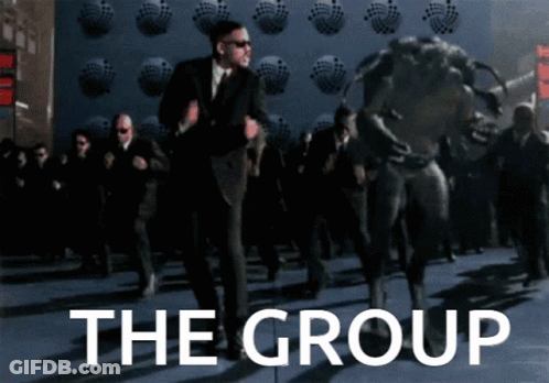 Man In Suit Dancing In Front Of The Group Wall GIF
