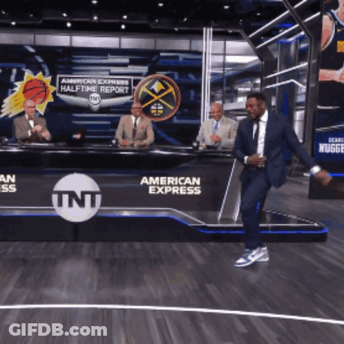 Man In Suit Dancing In Front Of TNT American Express Sign GIF