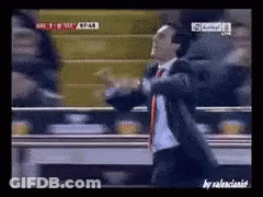 Man In Suit Dancing In Front Of TV Saying NFC GIF