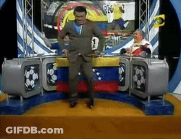 Man In Suit Dancing In Front Of TV With Number 3 GIF