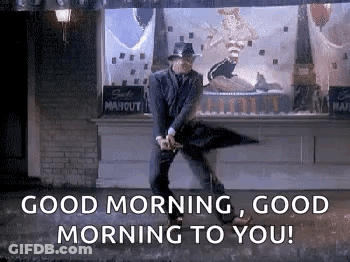 Man In Suit Dancing In Rain With Umbrella GIF