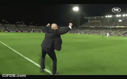 Man In Suit Dancing On Soccer Field With Fox Logo GIF
