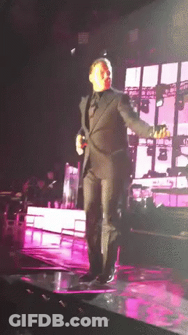 Man In Suit Dancing On Stage GIF