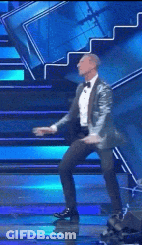 Man In Suit Dancing On Stage GIF