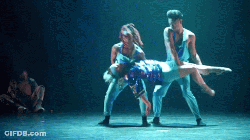 Man In Suit Dancing On Stage While Another Man Looks On GIF