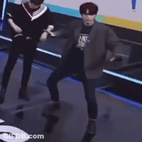 Man In Suit Dancing On Stage While Another Man Looks On GIF