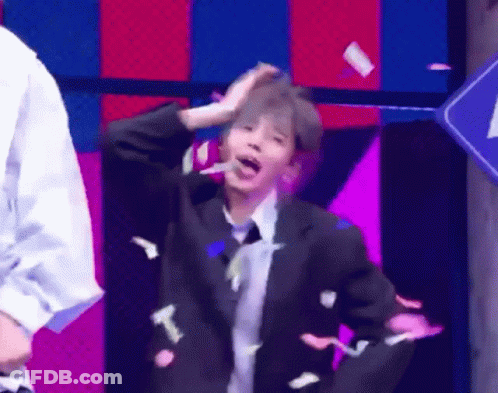 Man In Suit Dancing On Stage With Confetti GIF