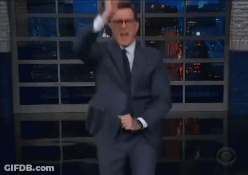 Man In Suit Dancing On Stage With Glass Wall GIF