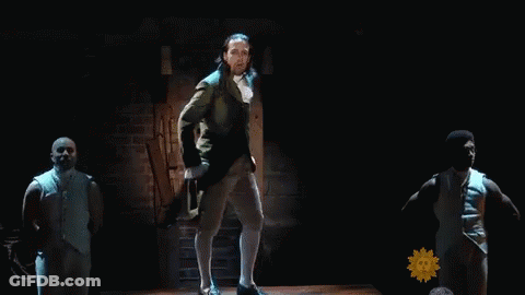 Man In Suit Dancing On Stage With Sunflower GIF