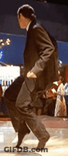 Man In Suit Dancing On Stage GIF