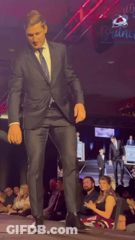 Man In Suit Dancing With Cherry Wine Sign GIF