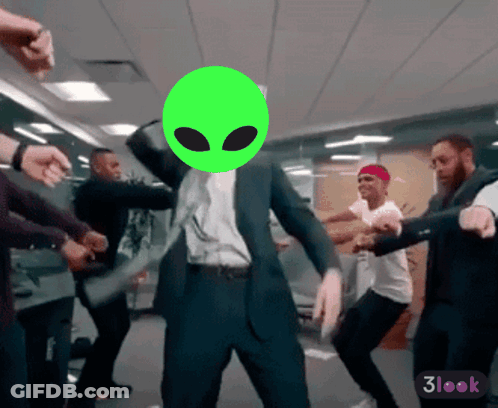 Man In Suit Dancing With Green Alien Head GIF