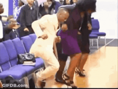 Man In Suit Dancing With Purple-Dressed Woman GIF