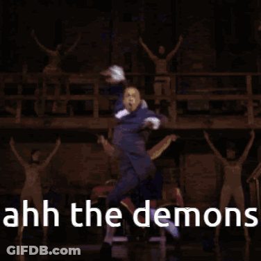 Man In Suit Dancing With Sword On Stage GIF