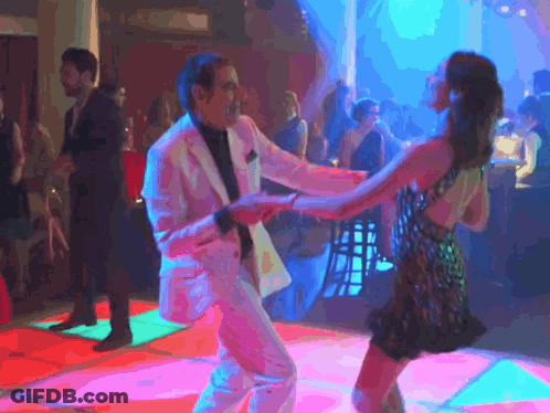 Man In Suit Dancing With Woman In Dress On Dance Floor GIF