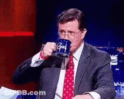 Man In Suit Drinking From Blue Mug Saying Good GIF