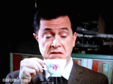Man In Suit Drinking From Flower Cup GIF