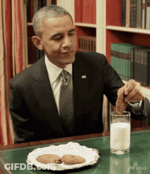 Man In Suit Drinking Milk And Eating Cookies GIF