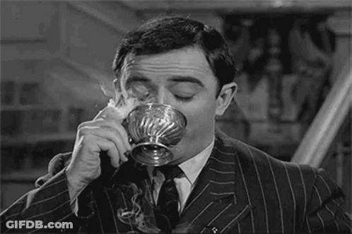 Man In Suit Drinking Silver Cup GIF