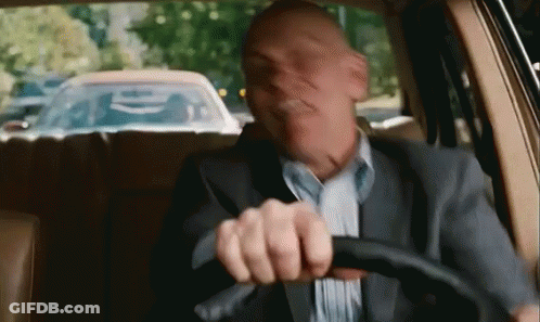 Man In Suit Driving Car Making Funny Face GIF