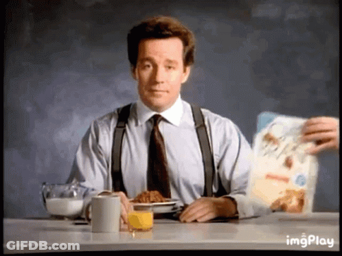 Man In Suit Eating Cereal And Drinking Orange Juice GIF