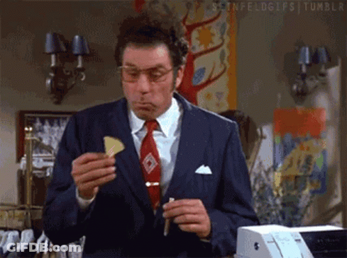 Man In Suit Eating Chip GIF