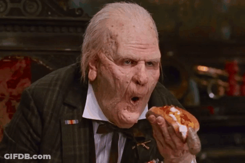 Man In Suit Eating Hot Dog With Ketchup And Mustard GIF