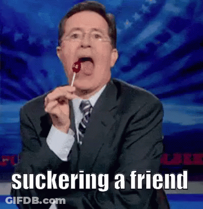 Man In Suit Eating Lollipop Suckering A Friend GIF