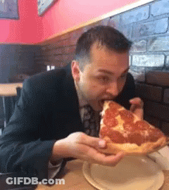 Man In Suit Eating Pepperoni Pizza GIF
