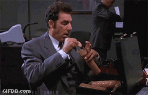 Man In Suit Eating Sausages From Briefcase GIF