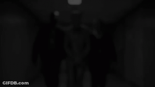 Man In Suit Escorted By Two Police Officers GIF