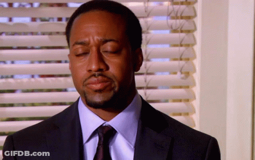 Man In Suit Eyes Closed By Window GIF
