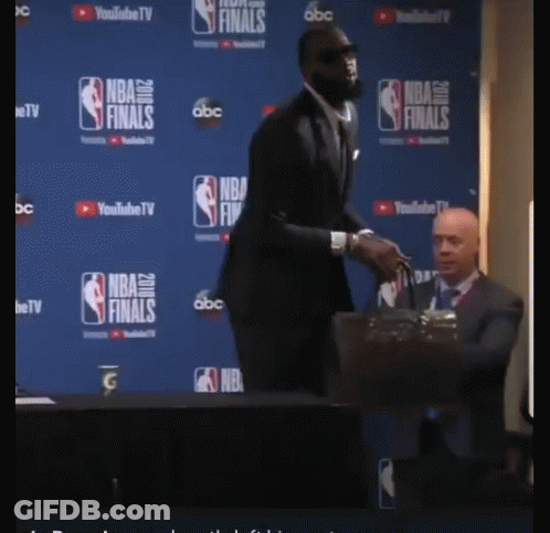 Man In Suit Facing NBA Finals Wall GIF
