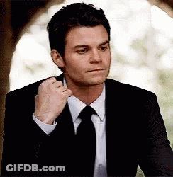 Man In Suit Fixing Tie GIF