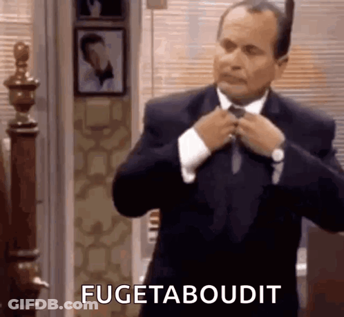 Man In Suit Fixing Tie Saying Fugetaboudit GIF