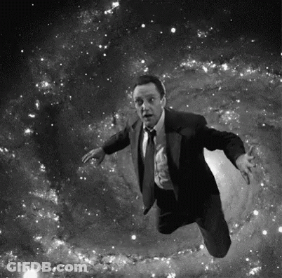 Man In Suit Flying Through Space GIF