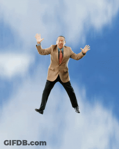 Man In Suit Flying With Arms Outstretched GIF