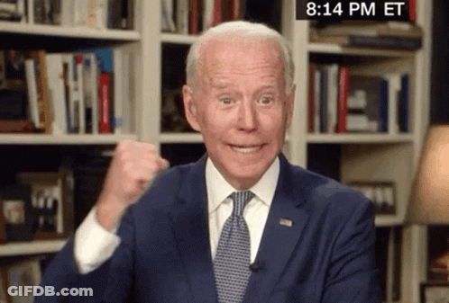 Man In Suit Giving Fist Bump In Front Of Bookshelf Saying 8:14 PM ET GIF