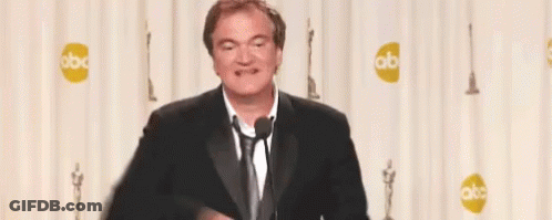 Man In Suit Giving Peace Sign At Microphone GIF