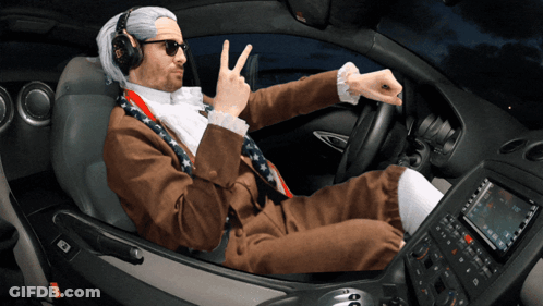 Man In Suit Giving Peace Sign GIF